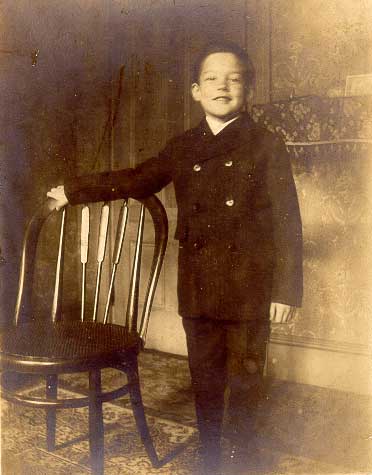 Philip standing by chair