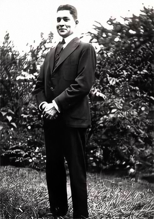 Philip standing in a suit wearing